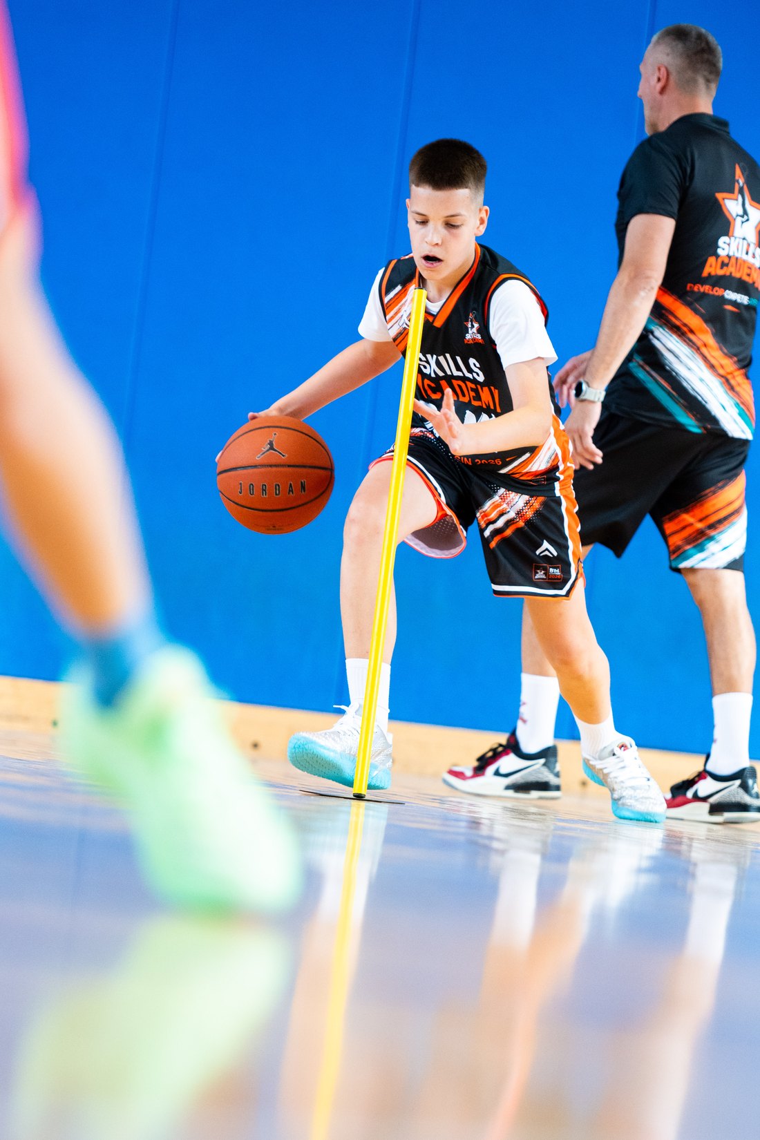 A camper finishing at the rim during a Skills Academy session
