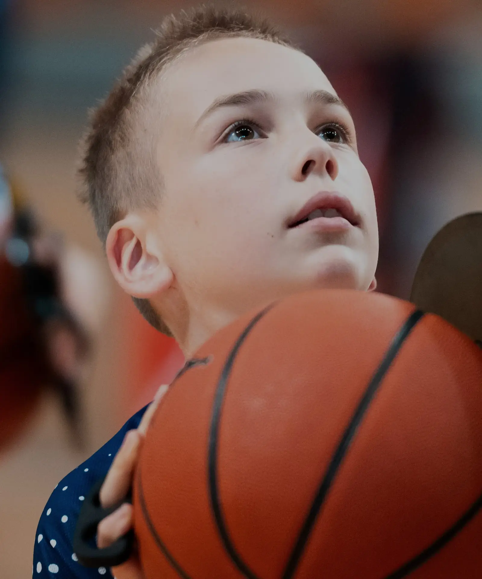 Young Skills Academy player looking up at the basket, ball in hands